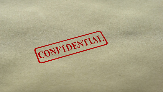 Confidential seal stamped on blank paper background, personal data nondisclosure