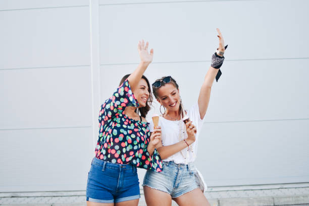 istock Beautiful women eating ice cream 1159018911
