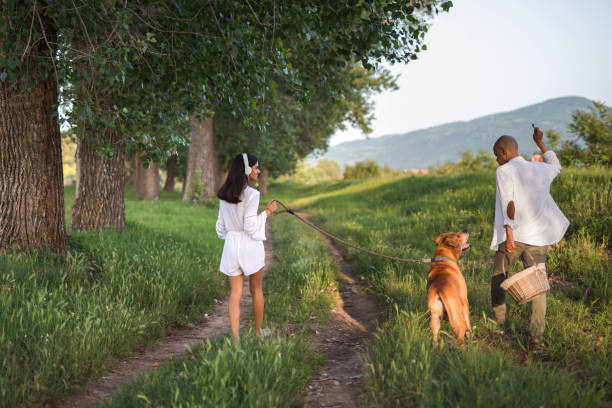 Father with daughter and dog walking in nature