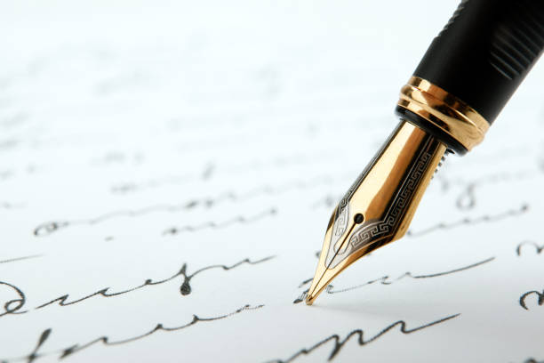fountain pen on paper with ink text on a white background closeup