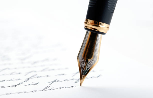 istock fountain pen on paper with ink text on a white background closeup 1159021455