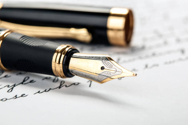 istock fountain pen on paper with ink text closeup 1159021458