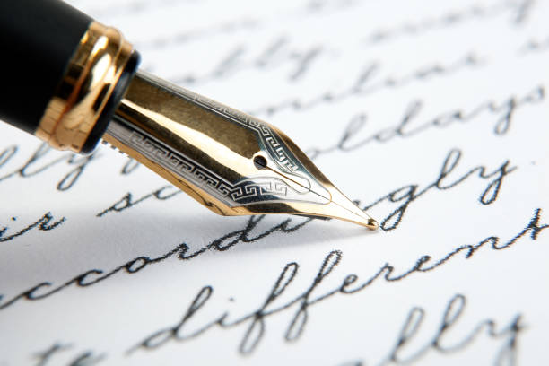 istock fountain pen on paper with ink text closeup 1159021462
