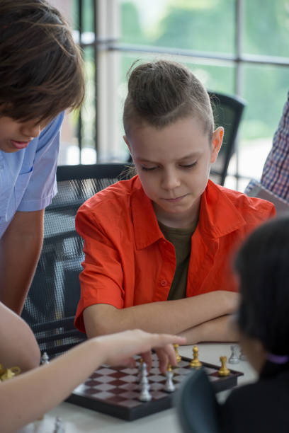 istock group Cute Children student playing chess game together in classroom at school . genius kid  . Great idea . child clever sitting at table . Early education .  . multiethnic 1159024774