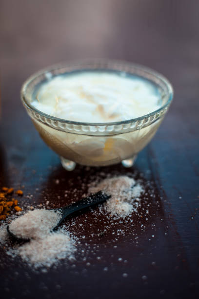 A bowl of curd or yogurt and some salt on wooden surface. A bowl of curd or yogurt and some salt on wooden surface. curd cheese stock pictures, royalty-free photos & images