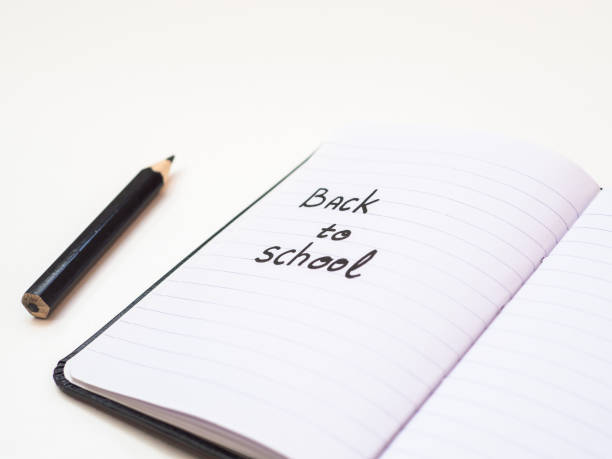 istock Back to school text written on notebook paper with pencil 1159025144