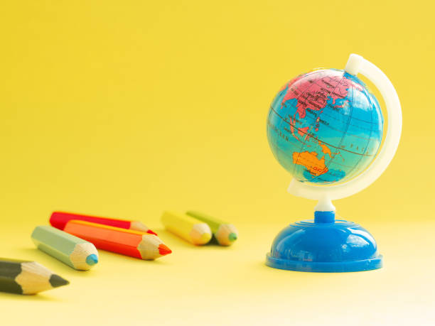 istock World map globe and multicolored pencils, education accessories 1159025153