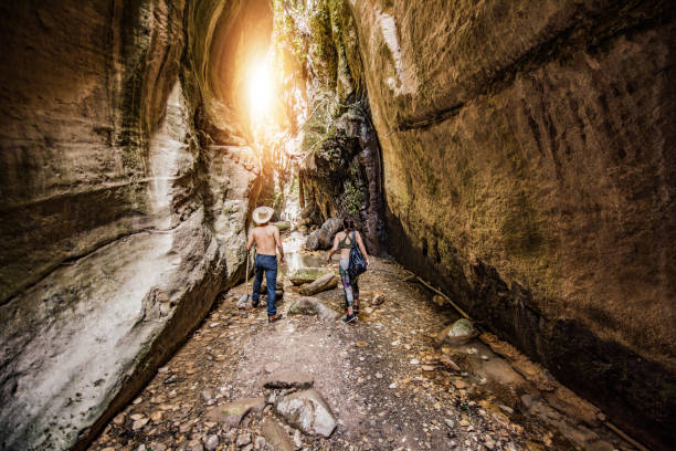 Hipster couple exploring a beautiful canyon on Cyprus island.  Avakas Gorge canyon.