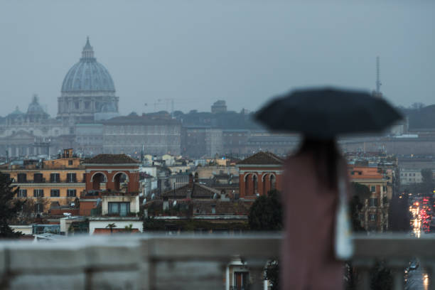 istock Melancholic Rome at sunset: woman under rain 1159026018