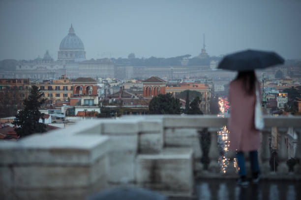 istock Melancholic Rome at sunset: woman with umbrella 1159026029