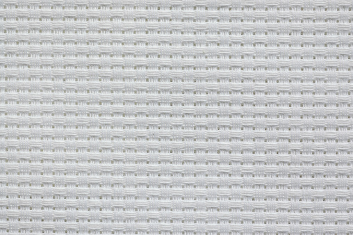 White herta cloth (course Aida cloth) is woven in a grid pattern. Used for cross stitch.
