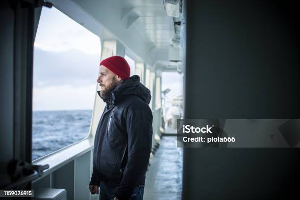 Man On A Vessel Sailing The Sea Stock Photo - Download Image Now - Sailor, Norway, People