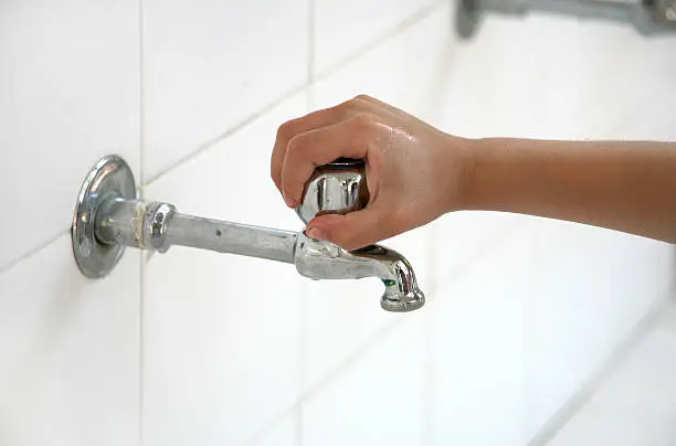 Photo of Hand on the tap