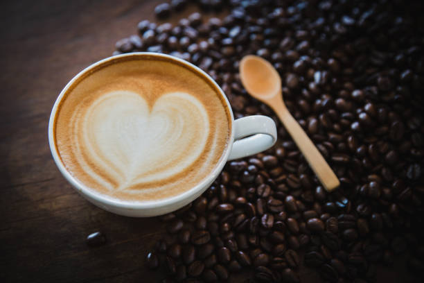 istock cup of coffee and coffee beans  on dark background, top view 1159028247