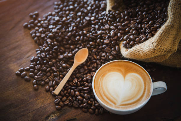 istock coffee latte with coffee beans  on dark background, top view 1159028248