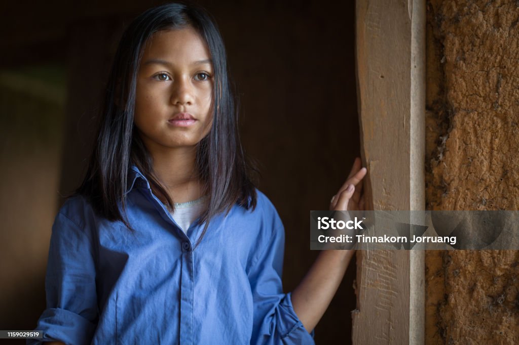 Portrait of a poor little thailand girl lost in deep thoughts, poverty, Poor children Portrait of a poor little thailand girl lost in deep thoughts, poverty, Poor children, War refugees Child Stock Photo