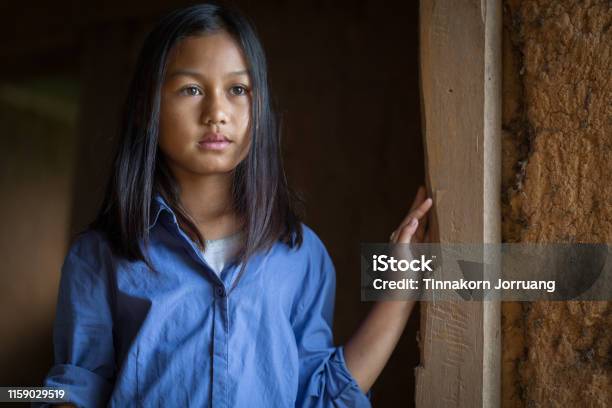 Portrait Of A Poor Little Thailand Girl Lost In Deep Thoughts Poverty Poor Children Stock Photo - Download Image Now