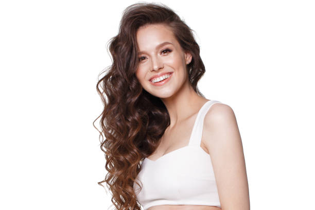 beautiful young girl in white dress with natural make-up, hair curls and smile. - sensuality lifestyles cheerful comfortable imagens e fotografias de stock