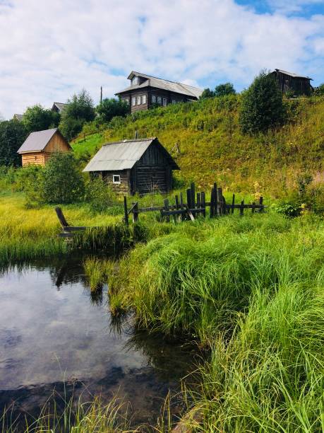istock Summer landscape with old house, lake, forest and sky 1159030243
