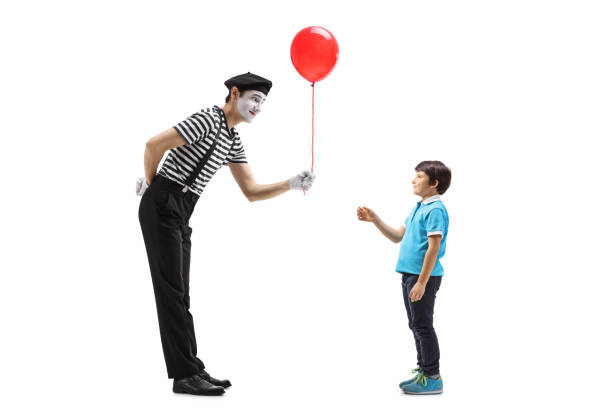 istock Mime giving a red balloon to a little boy 1159031587