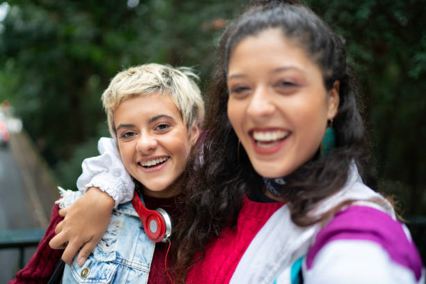istock Latin friends taking a selfie in the park 1159033502