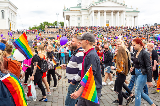 Helsinki Finland- June 29, 2019:  \nHelsinki pride parade gathering in finland. Almost 100.000 people attended the pride parade in finland. The pic shows Pride parade people celebration in front of Helsinki cathedral.