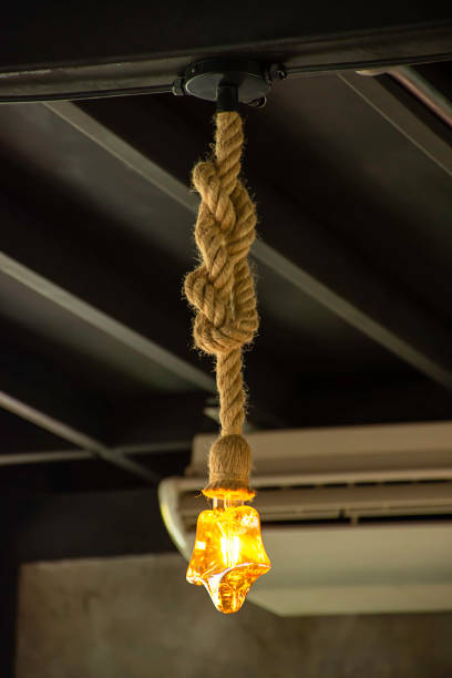 istock Yellow light bulb The star shaped hanging with a rope. 1159033764