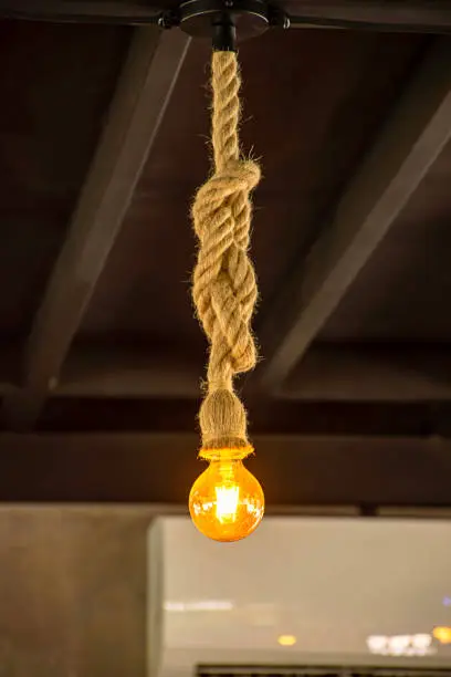Photo of Yellow light bulb The sphere hanging with a rope.