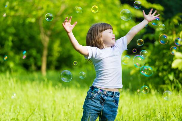 istock girl, soap bubbles, fun 1159033857