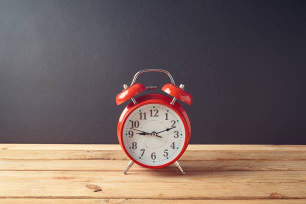 istock Alarm clock on wooden table. Back to school concept 1159034030