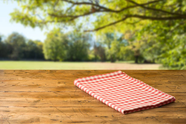 istock Empty wooden table with tablecloth over autumn nature park background 1159034113