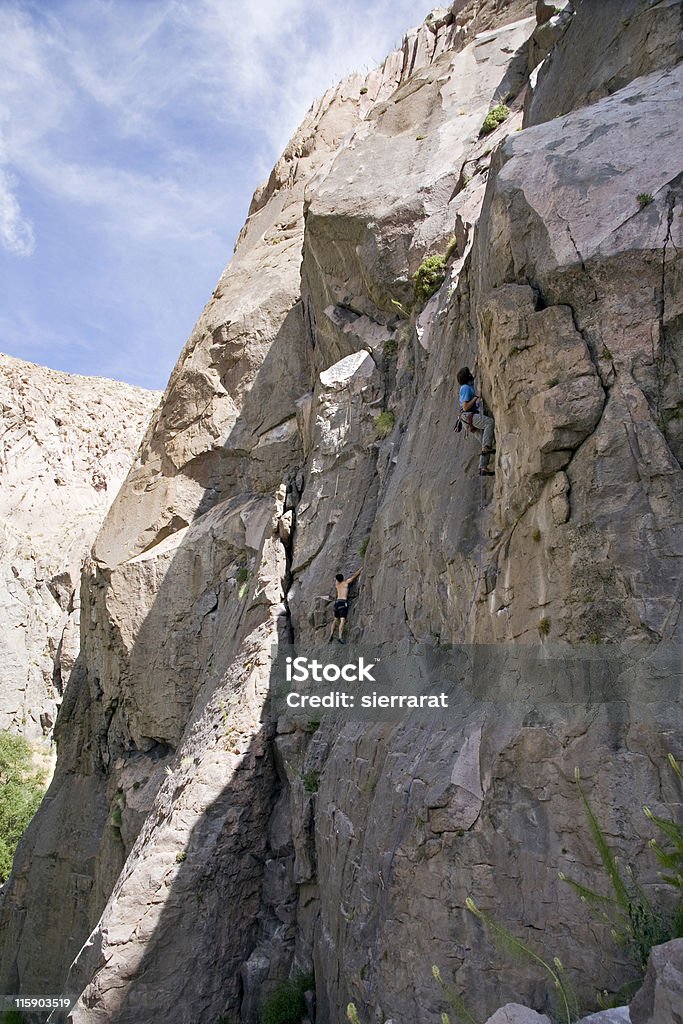 Sport Rock Climber Two male sport rock climbers scaling a shear cliff face in California's Owens River Gorge. 16-17 Years Stock Photo