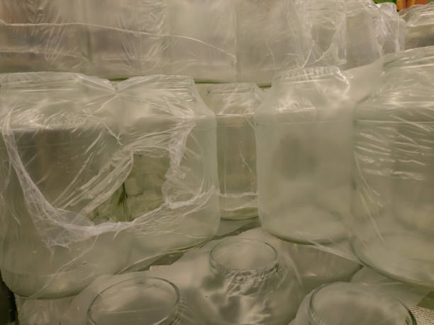 istock Empty glass containers wrapped in polyethylene on top of each other for drinks and other things in stock