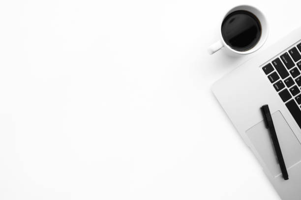 istock White office desk table with laptop computer, cup of coffee and pen. Top view with copy space, flat lay. 1159035225