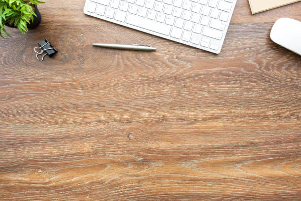 istock Wood office desk table with computer tools and supplies. Top view with copy space, flat lay. 1159035235