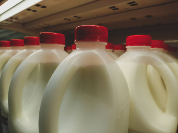 istock Milk in plastic bottles with red caps, close-up