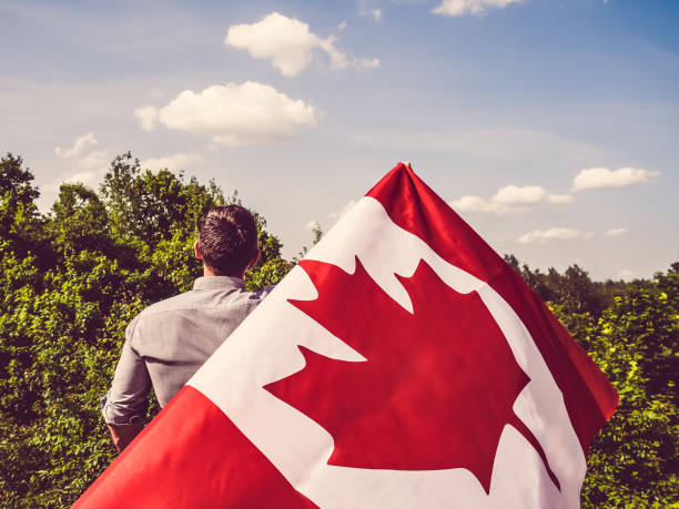 istock Man waving a Canadian Flag. National holiday 1159036111
