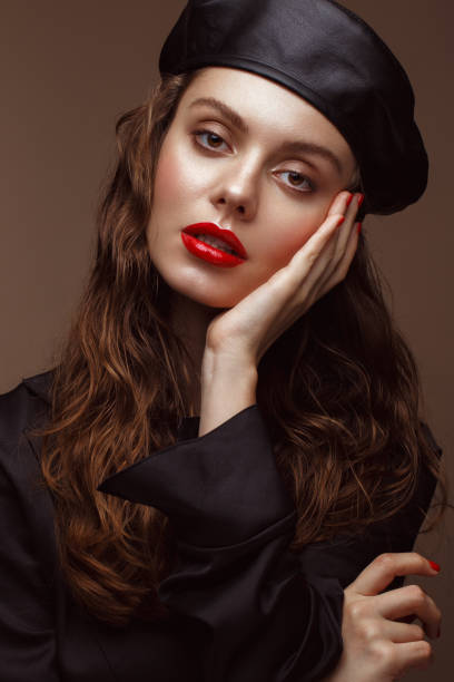 istock Beautiful brunette model with curls, classic makeup and sexy lips. 1159036222