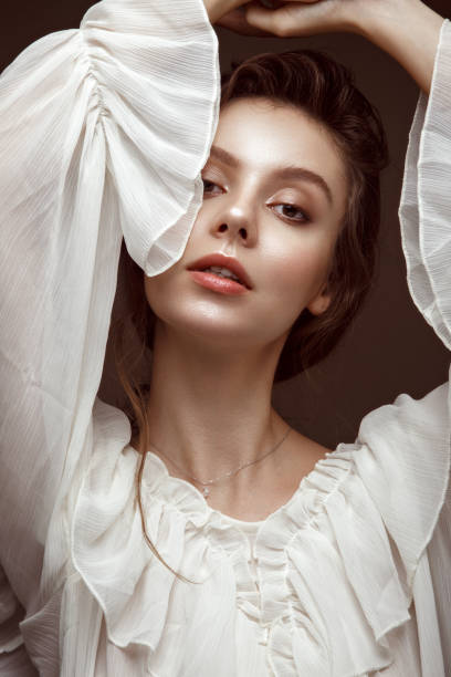 istock Beautiful brunette model with curls, classic makeup and sexy smile. 1159036271