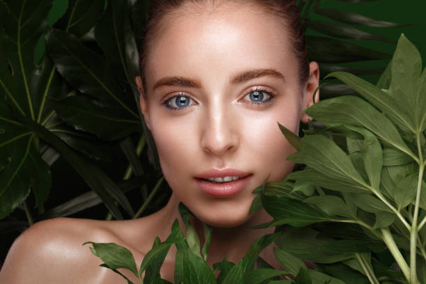 istock girl with green leaves. 1159036312