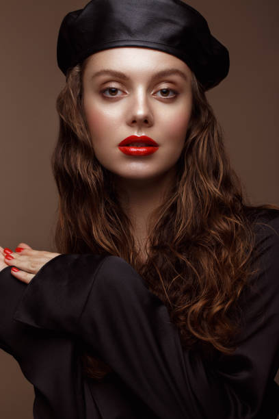 istock Beautiful brunette model with curls, classic makeup and sexy lips. 1159036456
