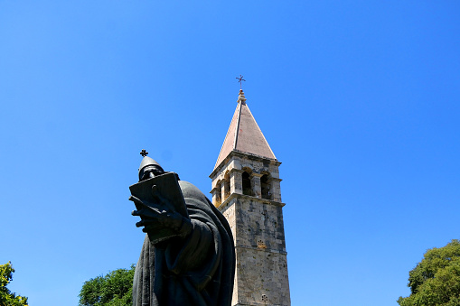 Historical bell tower and statue of bishop Grgur Ninski, landmarks in Split, Croatia.