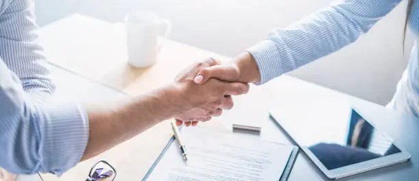 Photo of Business people shaking hands, finishing up meeting.