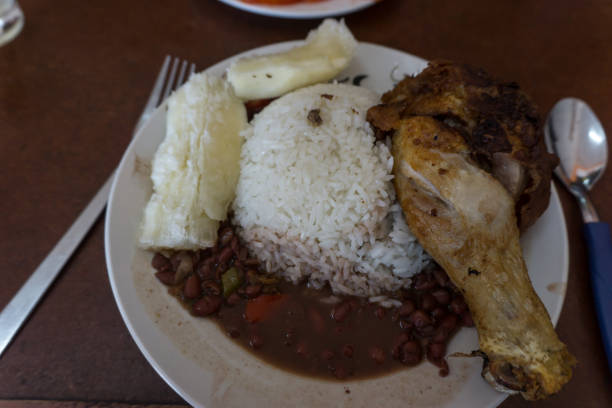 istock cuban food. fried chicken with rice and beans 1159040199