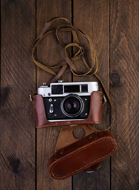 istock Vintage old camera on rustic wooden background. Top view 1159040747