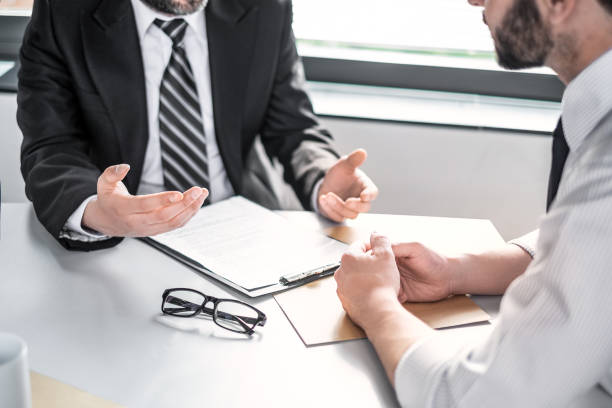 Business people negotiating a contract. Business people negotiating a contract. Human hands working with documents at desk and signing contract. clerk jobs hiring stock pictures, royalty-free photos & images