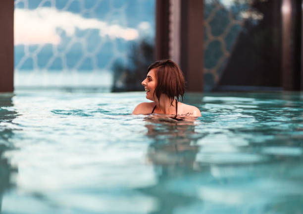 istock young woman swimming in the pool 1159041748