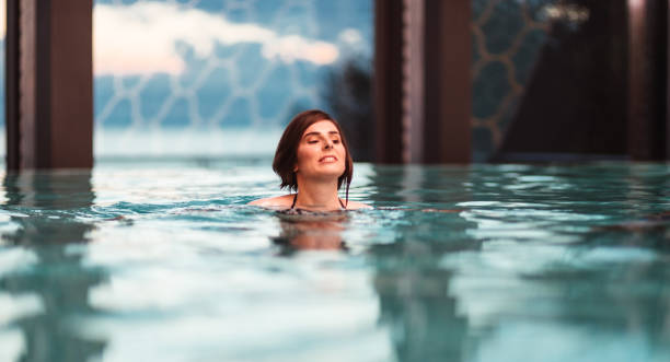 istock young woman swimming in the pool 1159043097