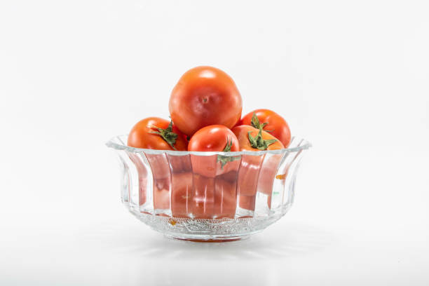 istock Tomatoes in crystal bowls. White background. It was taken in the studio. 1159043130