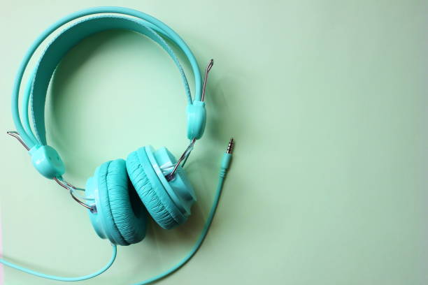 istock Headphones turquoise on a light green background. Copy Space. 1159044172